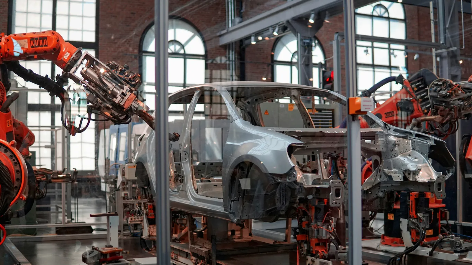 Robotic arms on a car assembly line, representing automotive-sector interpreting