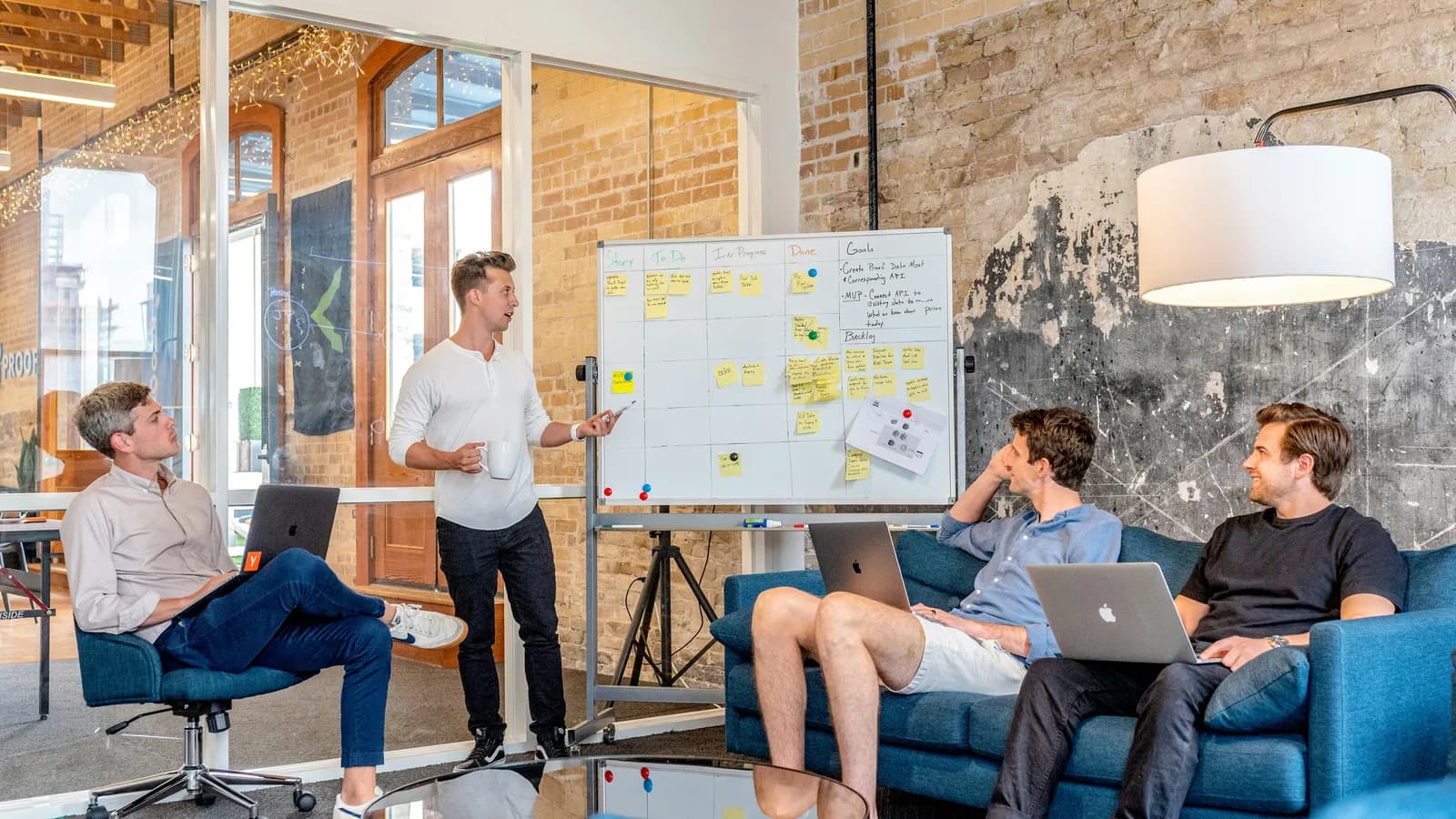 Team reviewing a whiteboard in an office, representing tech-sector interpreting