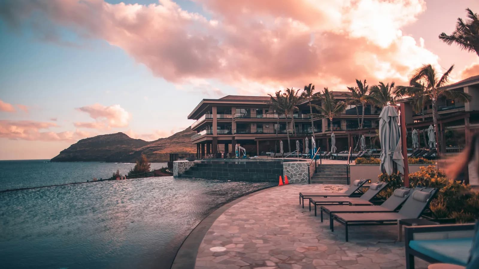 Resort building with an infinity pool, representing tourism and hospitality interpreting