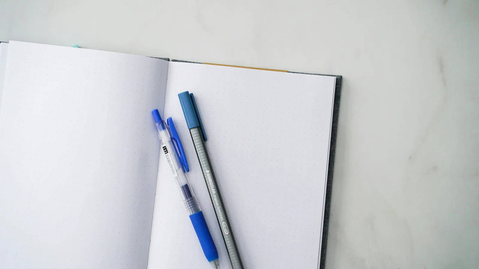 Notebook and pen on a desk, representing no-equipment consecutive interpreting