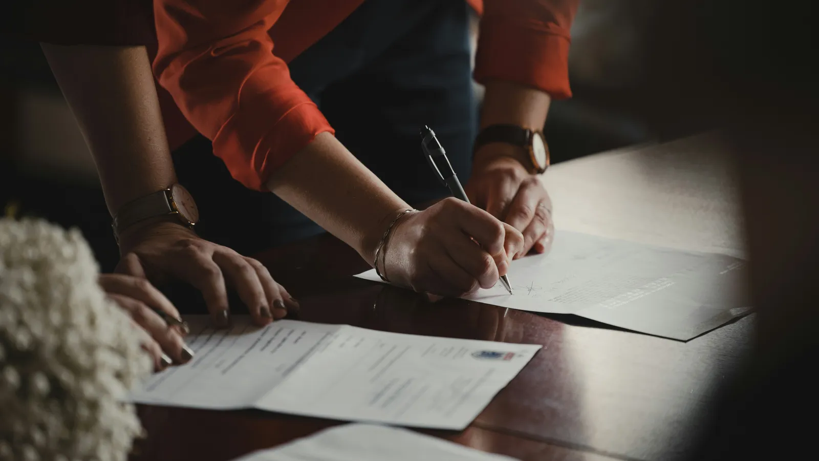 People signing documents, representing notarial interpreting