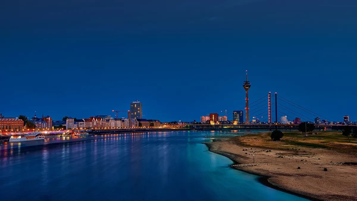 Düsseldorf skyline and the Rhine at night, seen from the Oberkasseler Brücke