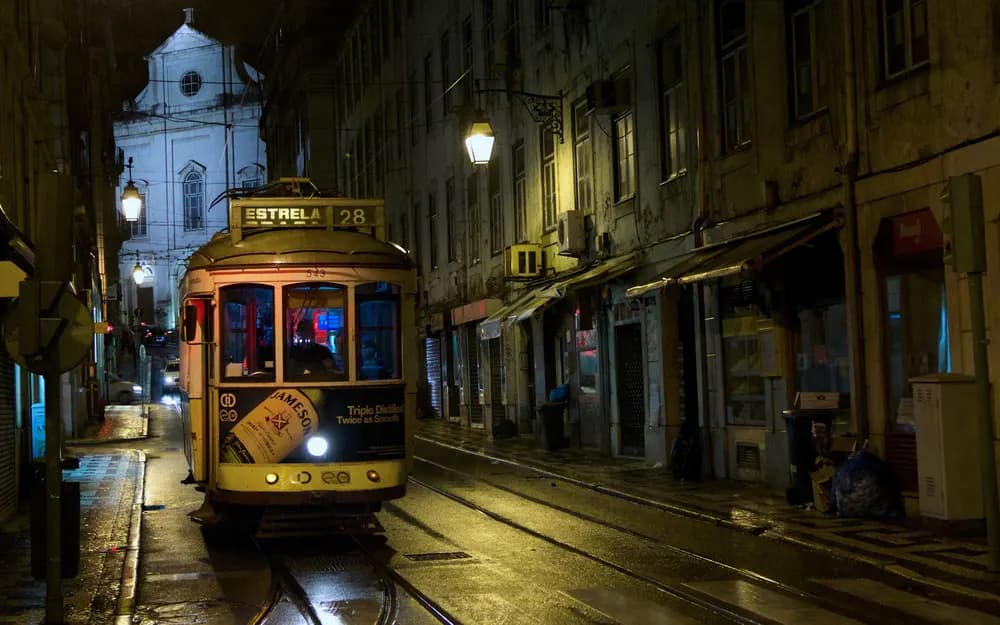 Tram 28 on a Lisbon street at night