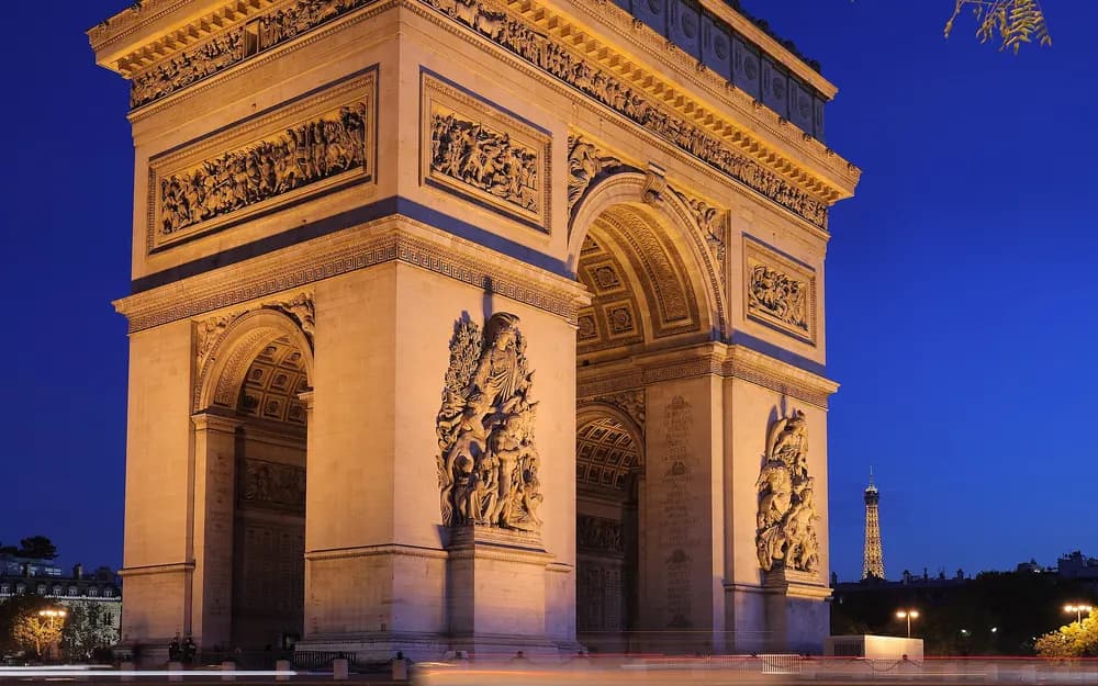 The Arc de Triomphe at twilight, with the Eiffel Tower in the background, Paris