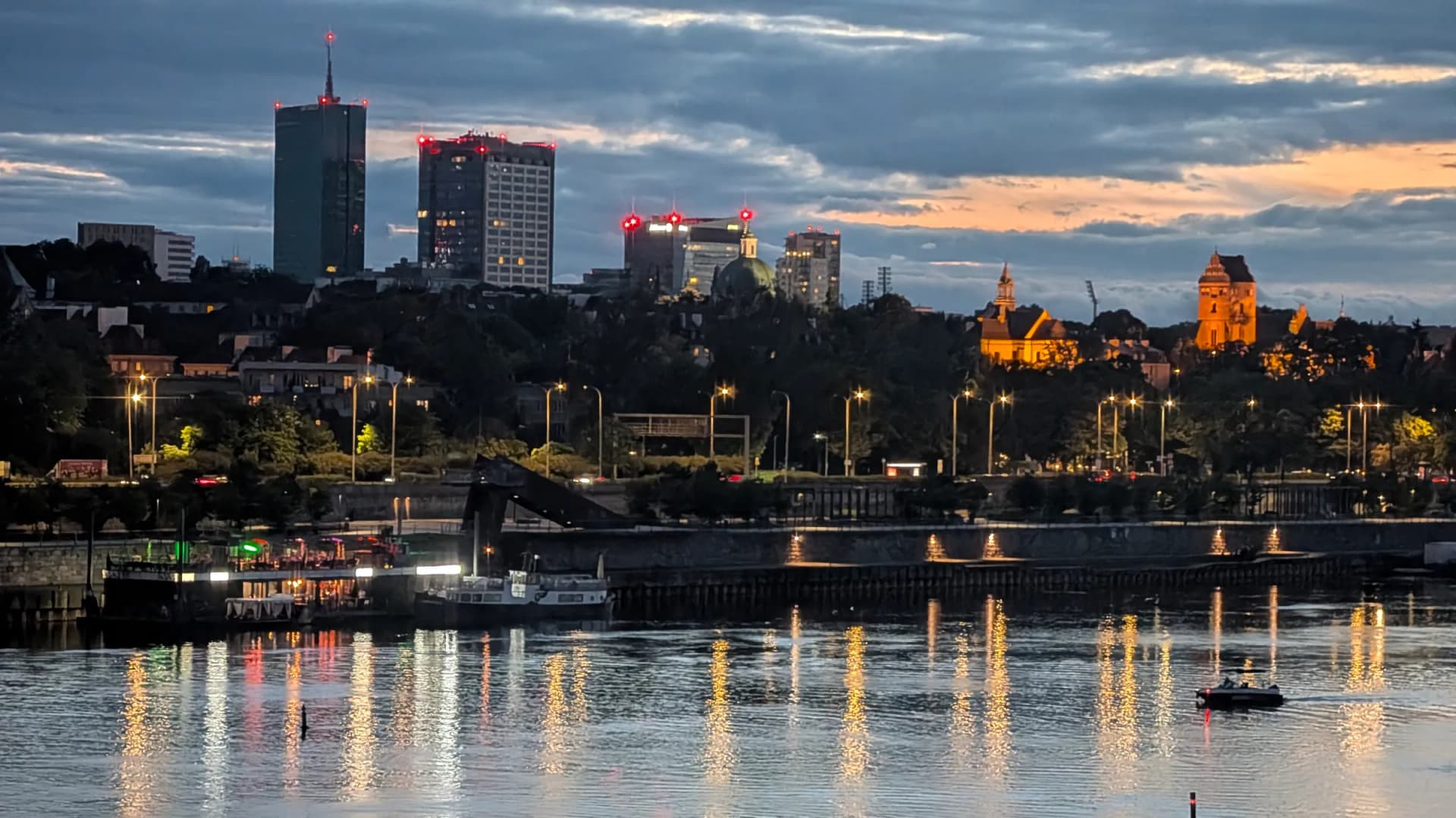 Evening skyline of Warsaw skyscrapers along the Vistula River