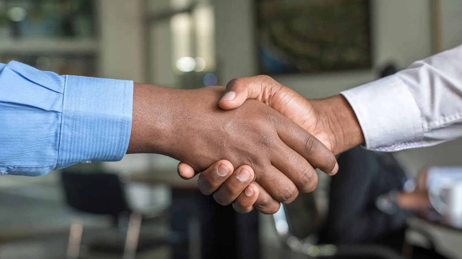 Business partners shaking hands, representing trade-mission interpreting
