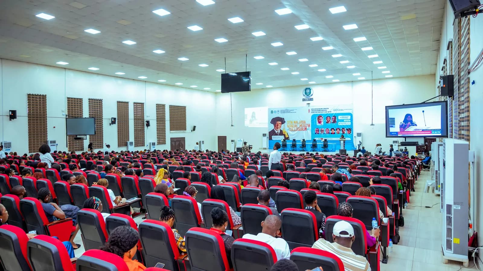 Audience seated in a large conference hall, representing conference interpreting