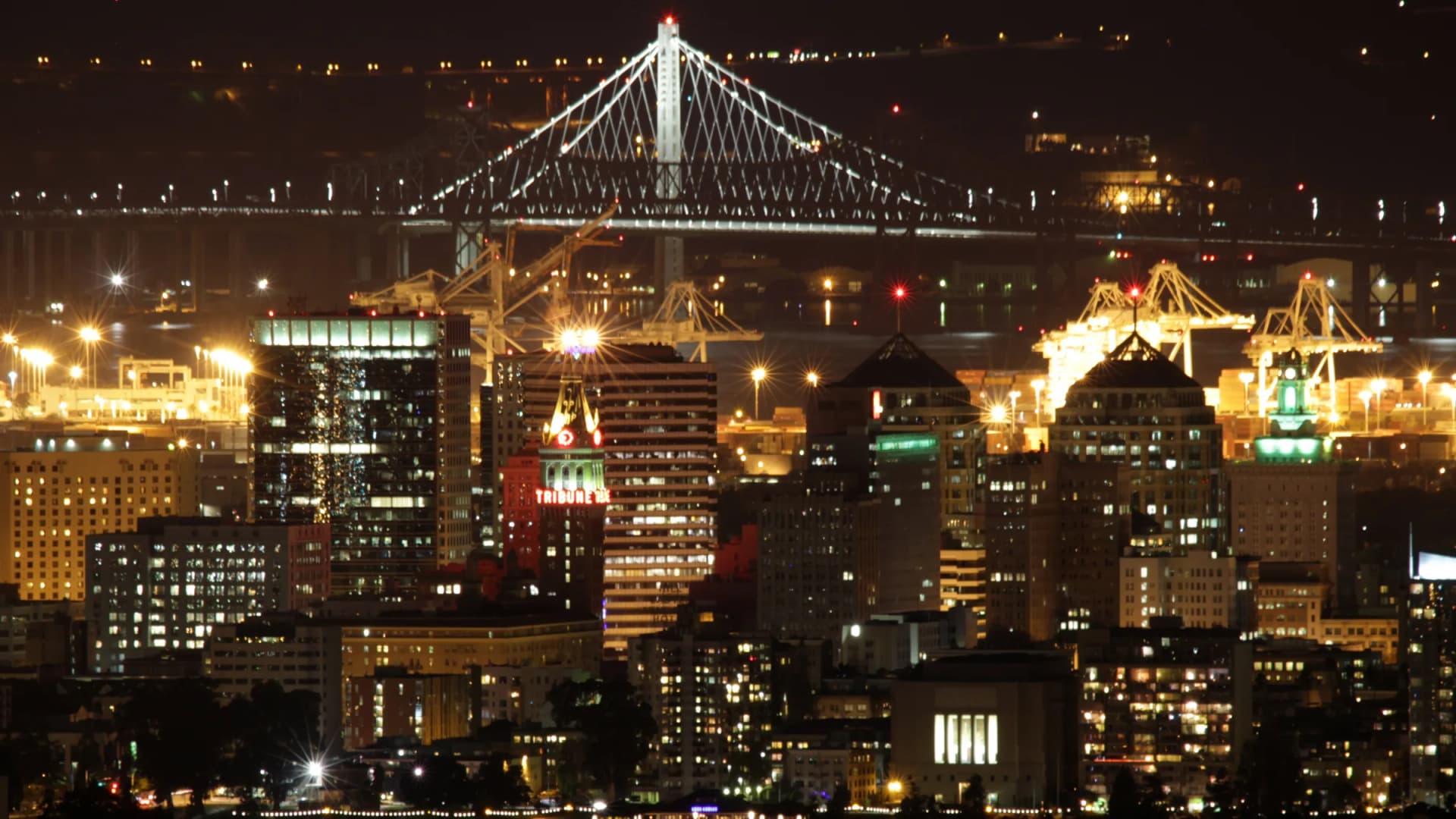 Oakland, California night skyline with the Bay Bridge