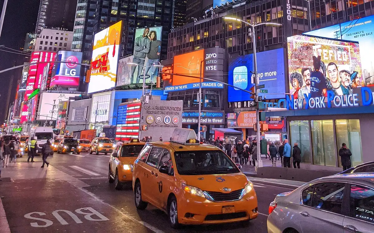 Billboards and yellow taxis in Times Square at night, Manhattan