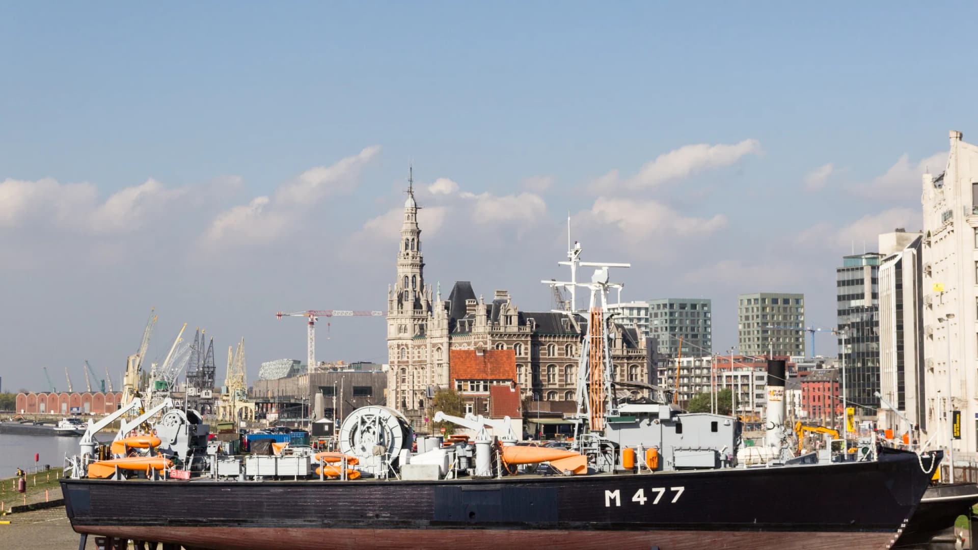 A ship passing the Antwerp skyline on the Scheldt River