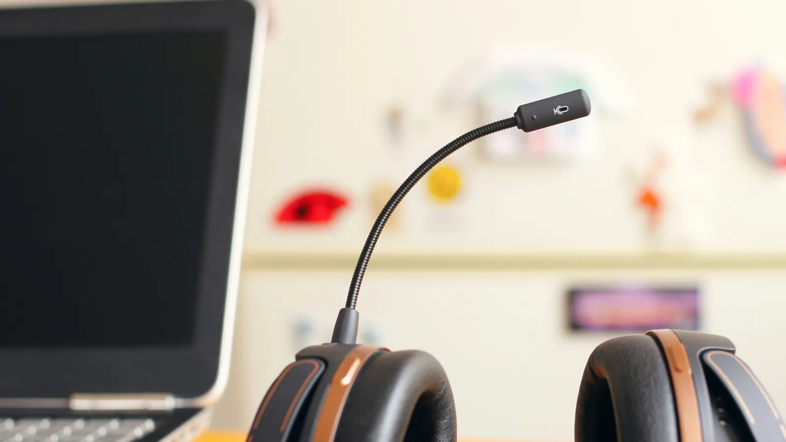 Headset beside a laptop, representing conference interpreting equipment
