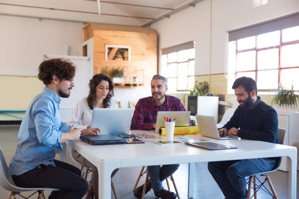 A project team meeting in an open-plan office