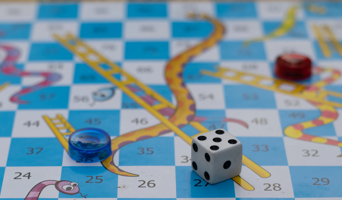 Primo piano di un dado e pedine colorate su un gioco da tavolo