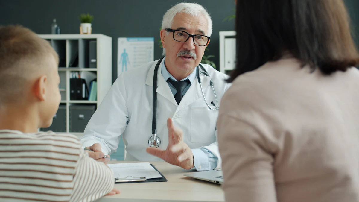 A clinician explaining something across a desk to a parent and child