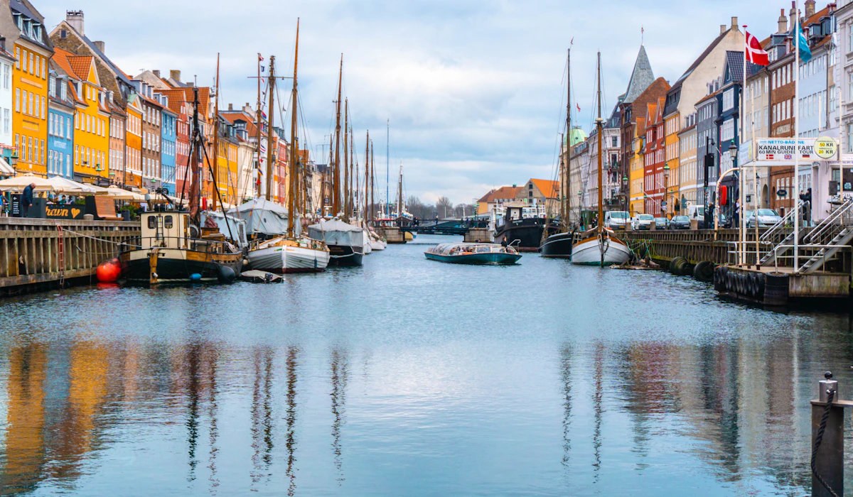 Colorful waterfront houses and moored boats along Copenhagen's Nyhavn canal