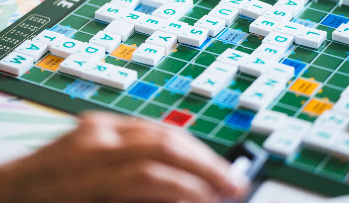 A close-up of a Scrabble board with tiles spelling out words