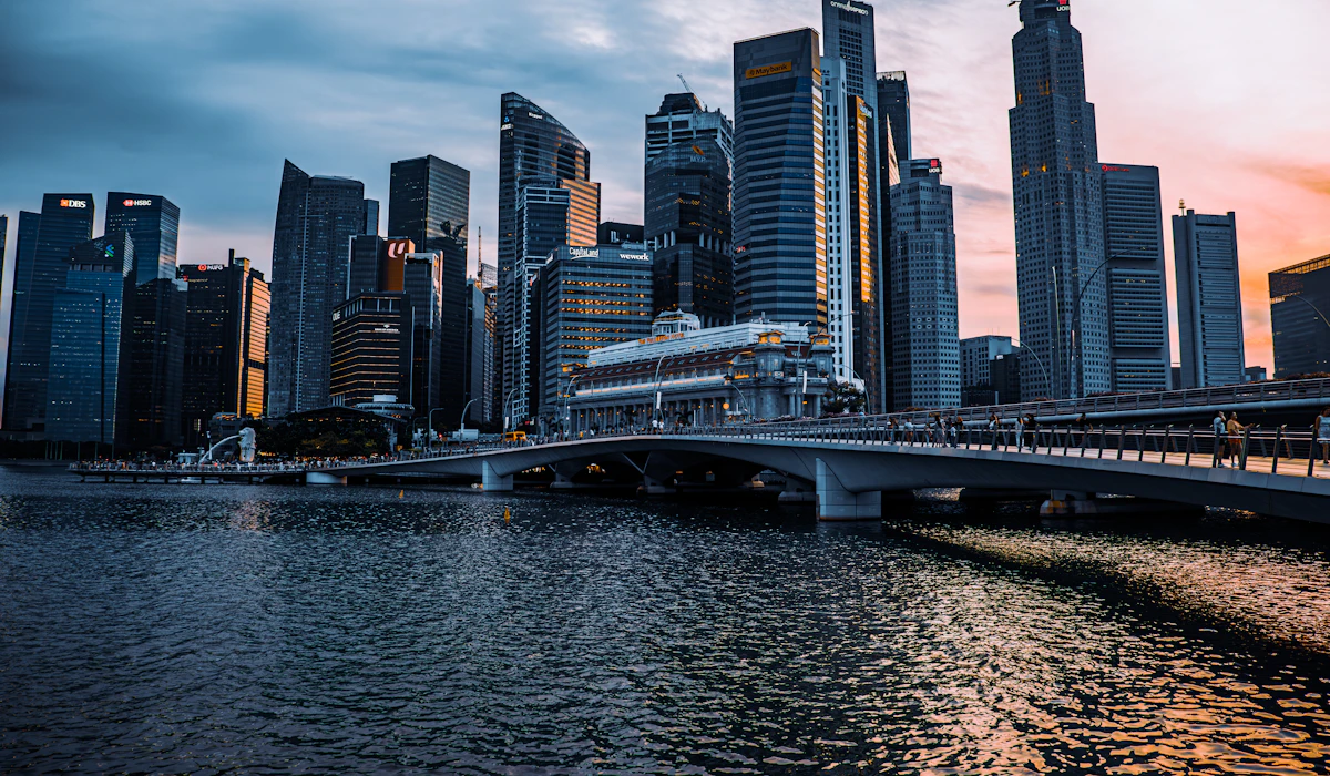 Singapore's skyline and Marina Bay at dusk, with the Merlion visible along the waterfront