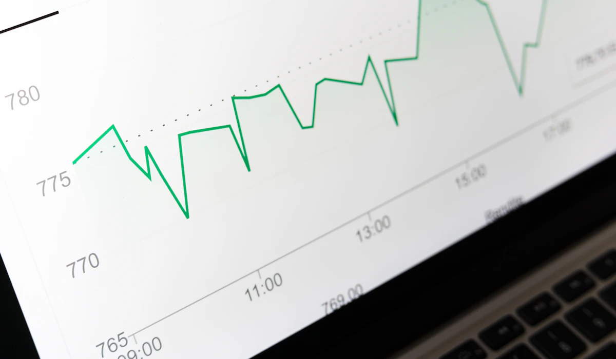 A green upward-trending line chart displayed on a laptop screen