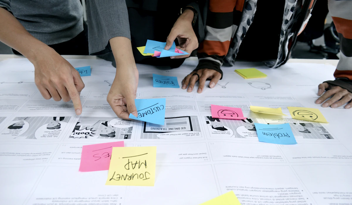 A team sorting colored sticky notes during a brainstorming session
