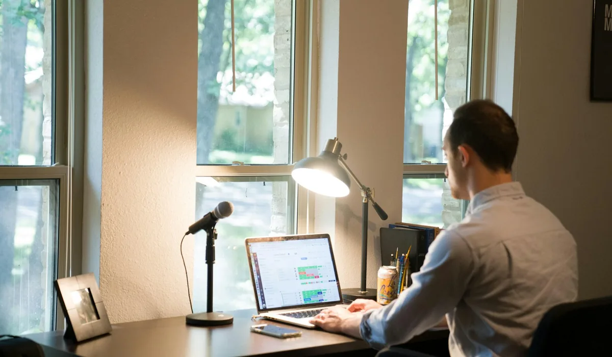 A freelance translator working calmly at a laptop from a home desk